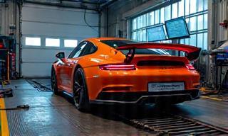 Car on a dynamometer undergoing a performance testing run with equipment visible.